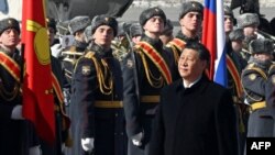 China's President Xi Jinping walks past honour guards during a welcoming ceremony at Moscow's Vnukovo airport on March 20, 2023.