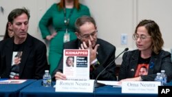 From left, Ruby Chen, father of kidnapped Israeli soldier Itay Chen, and Ronen and Orna Neutra, parents of Omer Neutra, join families of hostages and victims of the Hamas attacks at a House Foreign Affairs Committee session in Washington, Nov. 29, 2023.