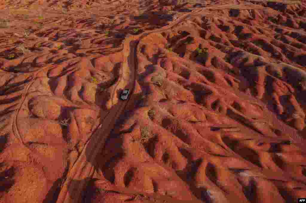 Aerial view showing a car riding along a dirt road in the Desert of Gilbues, in Gilbues, in the northeastern state of Piaui, Brazil.&nbsp;Gilbues is Brazil&#39;s worst desertification hotspot, where a parched, canyon-pocked landscape is swallowing up farms and residences, claiming an area bigger than New York City.&nbsp;