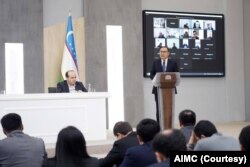 AIMC Tashkent: Asadjon Khodjaev, right, head of Uzbekistan's Agency on Information and Mass Communications, and his deputy Dilshod Saidjonov, left, speak with journalists and bloggers in headquarters, Tashkent, Dec 7, 2023. (AIMC)