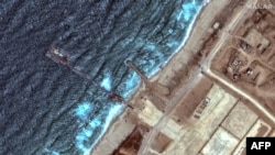 FILE - This handout satellite image courtesy of Maxar Technologies shows the U.S.-built Trident Pier on the coast of Gaza on May 26, 2024.