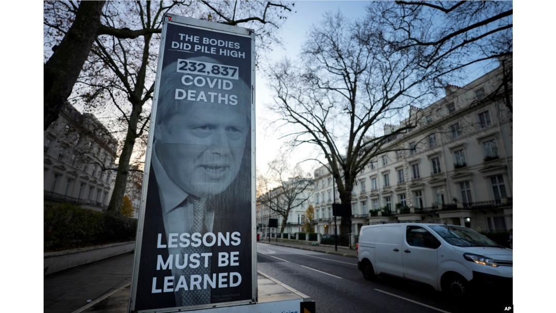 A van displaying a protest banner is parked outside the Covid-19 Inquiry in London, Dec. 6, 2023.