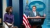 White House press secretary Karine Jean-Pierre, left, listens to National Security Council spokesman John Kirby speak at the White House in Washington, Oct. 12, 2023. Creating a humanitarian corridor to enable aid to reach Palestinians in Gaza is 'the right thing to do,' he said.