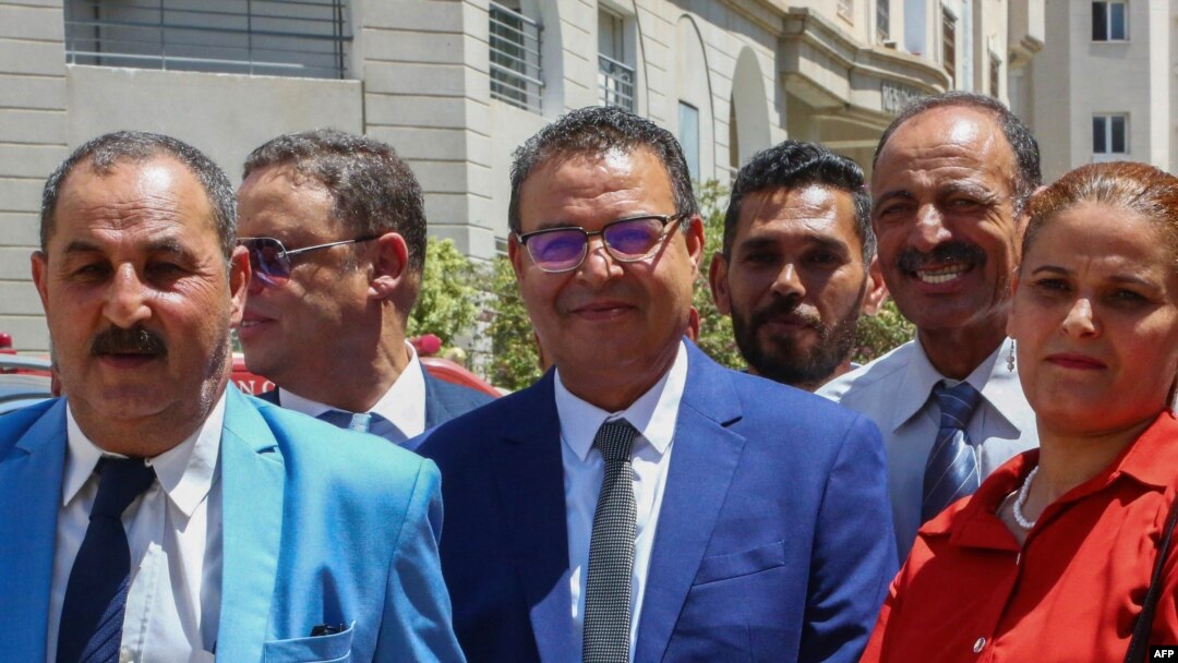 General Secretary of the People's Movement party Zouhair Maghzaoui (C) poses for a picture with members of his party after submitting his candidacy for the Oct. 6 presidential election in Tunis, Aug. 6, 2024.
