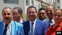 General Secretary of the People's Movement party Zouhair Maghzaoui (C) poses for a picture with members of his party after submitting his candidacy for the Oct. 6 presidential election in Tunis, Aug. 6, 2024.