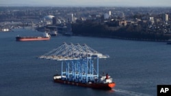 FILE - The Zhen Hua 31 heavy-lift ship carries four super-post Panamax container cranes into Commencement Bay, in Tacoma, Washington, March 5, 2019. The cranes were purchased by from Shanghai Zhenhua Heavy Industries Co. Ltd. in China.