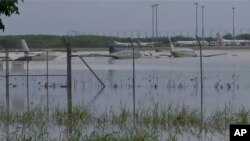 FILE - Partially-submerged small planes are seen at Cairns Airport in Cairns, Australia, Dec. 18, 2023, in this image from a video. More flooding is expected in northeast Australia as a storm gathers strength over the Coral Sea on Jan. 23, 2024. 