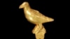 FILE — A gold ornament, in the form of a bird, probably from a ceremonial hat, pictured January 25, 2024. This artifact and others are being returned to Ghana decades after they were looted from the Ashanti people during Britain’s colonial battles in West Africa.