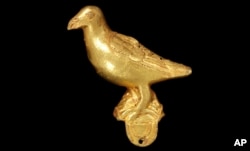 A gold ornament, in the form of a bird, probably from a ceremonial hat, pictured Jan. 25, 2024. This artifact and others are being returned to Ghana decades after they were looted from the Asante people during Britain’s colonial battles in West Africa.