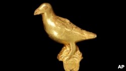 FILE — A gold ornament, in the form of a bird, probably from a ceremonial hat, pictured January 25, 2024. This artifact and others are being returned to Ghana decades after they were looted from the Ashanti people during Britain’s colonial battles in West Africa.