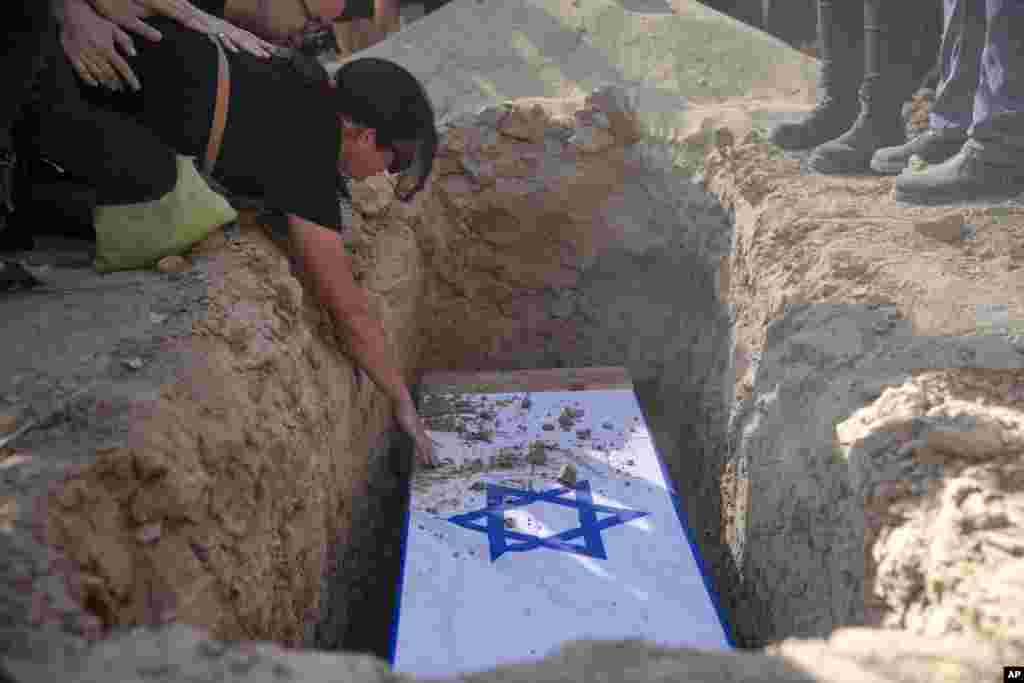 Rimon Buchshtab mourns during the funeral of her husband Yagev Buchshtab at a cemetery of the Kibbutz Nirim, southern Israel.&nbsp;&nbsp;Buchshtab&#39;s body was one of six bodies of hostages, taken in Hamas&#39; Oct. 7 attack, recovered by Israel&#39;s military during an operation in the Gaza Strip.