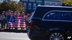 Boy scouts salute as the hearse moves during the funeral service for former first lady Rosalynn Carter in Plains, Georgia, Nov. 29, 2023.