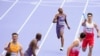 Quincy Wilson, of the United States, approaches teammate Vernon Norwood to handover the baton in a men's 4 x 400 meters relay round 1 heat at the 2024 Summer Olympics, Aug. 9, 2024, in Saint-Denis, France. 