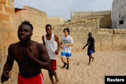 Shogo Uozumi, also known as Songo Tine, 29 years old, trains with his teammates at the Samba Dia stable in the Diakhao neighborhood, in Thies, Senegal, May 26, 2023. (REUTERS/Ngouda Dione)