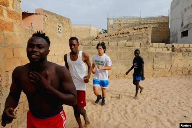 Shogo Uozumi, also known as Songo Tine, 29 years old, trains with his teammates at the Samba Dia stable in the Diakhao neighborhood, in Thies, Senegal, May 26, 2023. (REUTERS/Ngouda Dione)