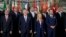 Participants at an International conference on migration pose for a family photo in Rome, July 23, 2023. 