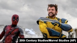 This image released by 20th Century Studios/Marvel Studios shows Ryan Reynolds as Deadpool/Wade Wilson, left, and Hugh Jackman as Wolverine/Logan in a scene from "Deadpool & Wolverine."