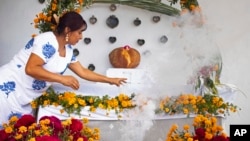 Ana Martinez prepares a Day of the Dead altar at her home's terrace in Santa Maria Atzompa, Mexico, Oct. 31, 2023.