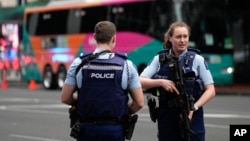 Police officers stand outside a hotel housing a team from the FIFA Women's World Cup in the central business district following a shooting in Auckland, New Zealand, July 20, 2023. 