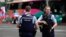 Police officers stand outside a hotel housing a team from the FIFA Women's World Cup in the central business district following a shooting in Auckland, New Zealand, July 20, 2023. 