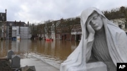 Rescue workers evacuate a person as the Aa river floods Arques, northern France, Jan.4, 2024.