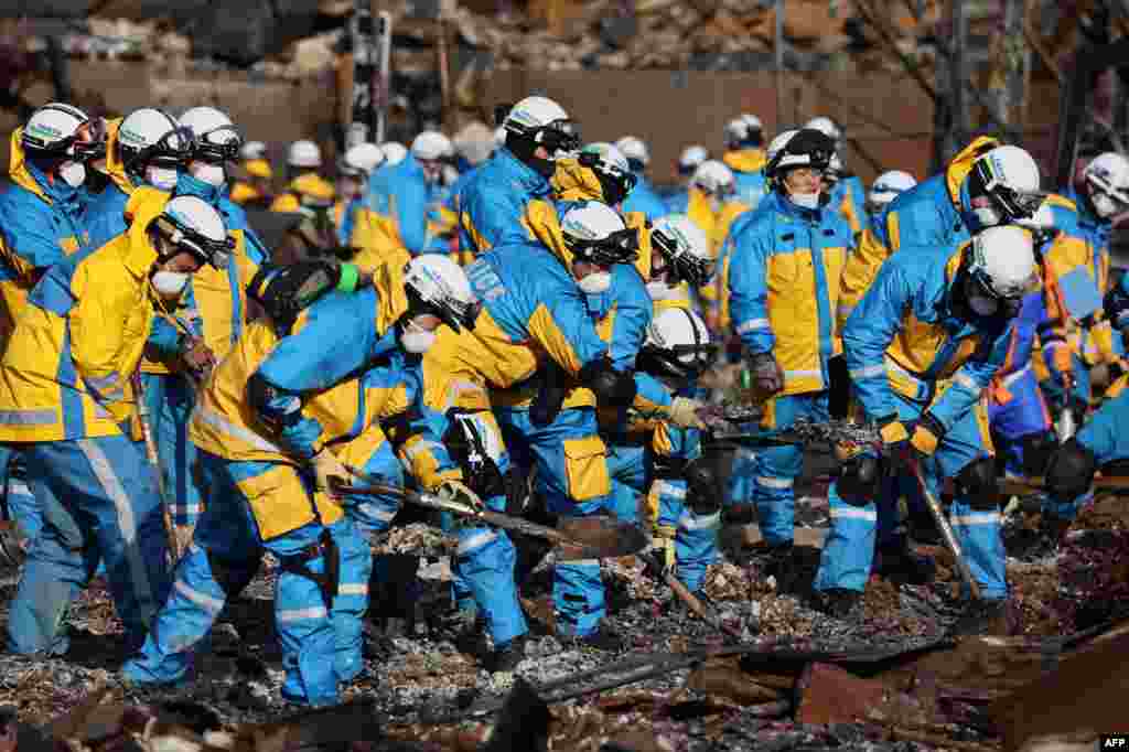 Police officers use shovels to work through the ruins of a popular shopping area that was destroyed by fire in the city of Wajima, Ishikawa prefecture, after a major 7.5 magnitude earthquake struck the region on New Year&#39;s Day.&nbsp;