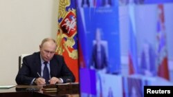 Russian President Vladimir Putin chairs a meeting on situation in Belgorod, Kursk and Bryansk regions following an incursion of Ukrainian troops, via video near Moscow, Aug, 22, 2024. (Sputnik/Gavriil Grigorov via Reuters)