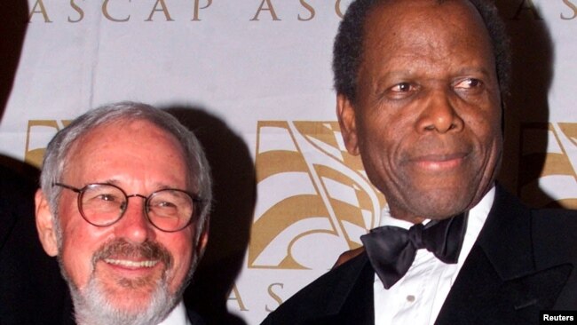 FILE - Canadian film director Norman Jewison, left, poses with actor Sidney Poitier in Beverly Hills, April 24, 2001.