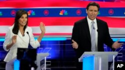 Former U.N. Ambassador Nikki Haley and Florida Gov. Ron DeSantis talk during a Republican presidential primary debate hosted by NBC News, Nov. 8, 2023, at the Adrienne Arsht Center for the Performing Arts of Miami-Dade County in Miami.