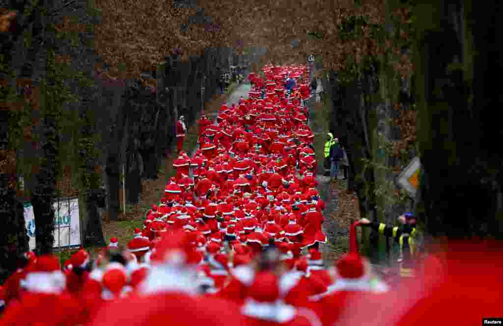 People dressed as Santa Claus run through the streets as they take part in the annual Nikolaus Lauf (Saint Nicholas run), in Michendorf, Germany.