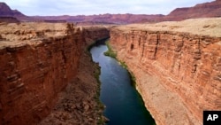 FILE - The Colorado River in the upper River Basin is seen, May 29, 2021, in Lees Ferry, Ariz. 