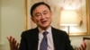 FILE - Thailand's former Prime Minister Thaksin Shinawatra responds to questions during a news interview in New York, March 9, 2016. 
