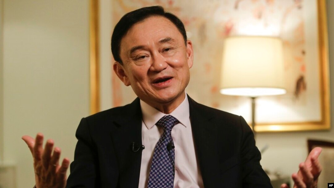 FILE - Thailand's former Prime Minister Thaksin Shinawatra responds to questions during a news interview in New York, March 9, 2016. 