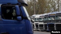 FILE - Ukrainian trucks wait at the Hungary-Ukraine border, in Zahony, Hungary, April 19, 2023. A protest by Hungarian truckers planned in Zahony on Dec. 11, reportedly will aim to slow the movement of trucks and demand restrictions on Ukrainian haulers working in the EU.
