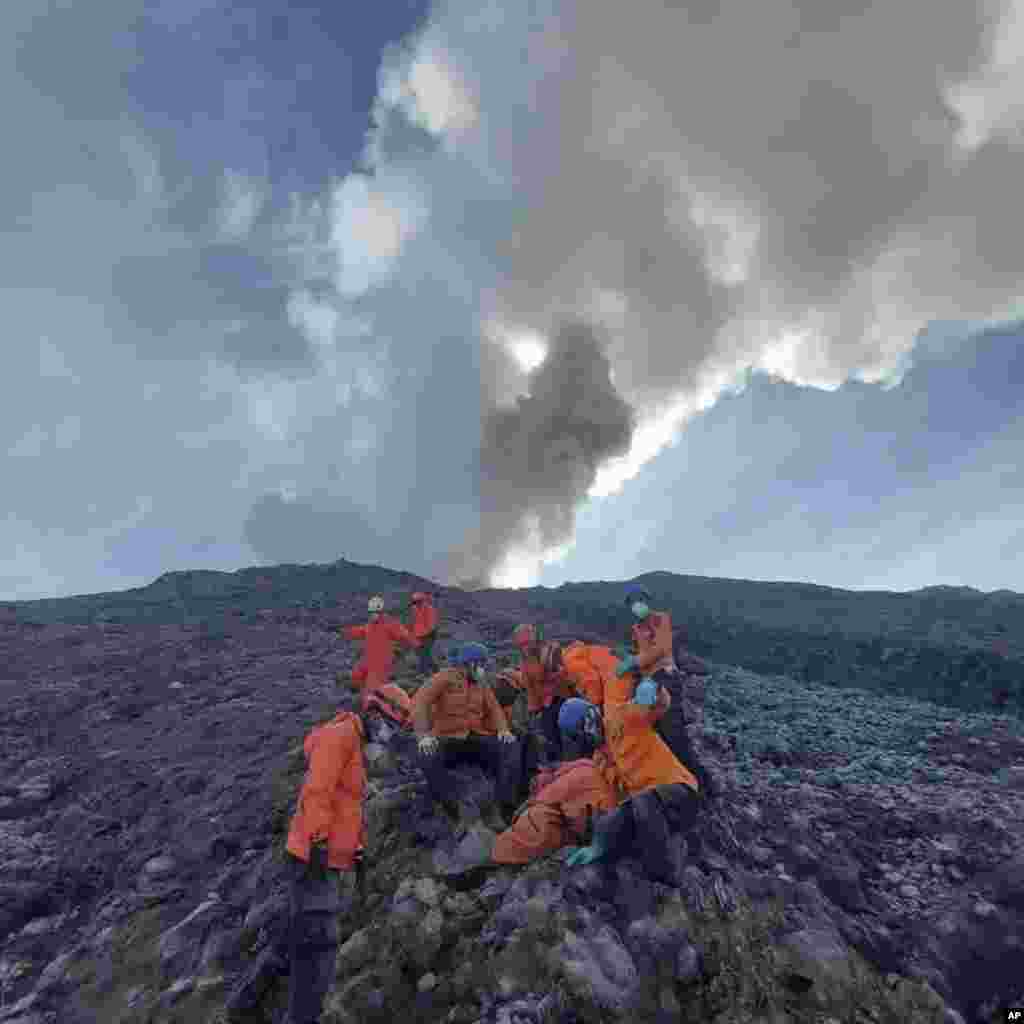 In this undated photo released by the Indonesian National Search and Rescue Agency (BASARNAS), rescuers prepare to evacuate the body of a climber killed in Mount Marapi&#39;s eruption in Agam, West Sumatra, Indonesia.