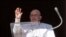 Pope Francis waves at the crowd, who are gathered on St Peter's Square during the Angelus prayer, from his window at the Vatican, Jan. 21, 2024. (Vatican Media/­Handout via Reuters)