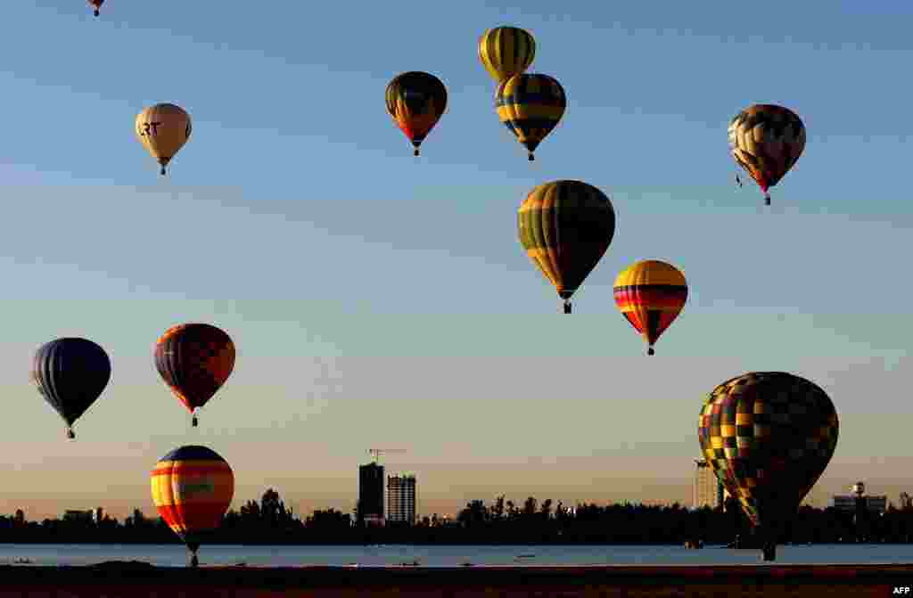 Hot air balloons fly during the third day of the 21st International Hot Air Balloon Festival in Leon, Guanajuato state, Mexico.