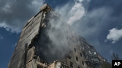 Smoke billows after a missile hit an apartment building in Kryvyi Rih, Ukraine, July 31, 2023.