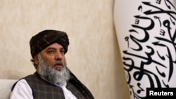 Taliban's acting commerce minister Haji Nooruddin Azizi speaks during an interview with Reuters, at the Embassy of Afghanistan in Beijing, China, Oct. 19, 2023. 