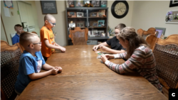 Yulia plays a board game with her brothers