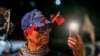 A supporter wears Taiwan national flags on his hat during an election campaign rally in Keelung on Jan. 4, 2024.