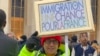 A protester of Algerian descent brandishes a sign reading "Immigration is a chance for France" at a rally against French migration legislation in Paris on Jan. 21, 2024. (Lisa Bryant/VOA)