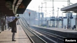 A man stands on a platform next to empty railway tracks at Cologne Deutz train station during a nationwide strike called by Germany's train drivers union GDL over unmet wage increase demands, in Cologne, March 7, 2024. 