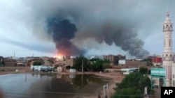 FILE: Smoke rises over Khartoum, Sudan, Wednesday, June 7, 2023. Saudi Arabia and the United States have urged Sudan's warring parties to agree to and "effectively implement" a cease-fire as the fighting in the northeastern African nation showed no signs of abating. 