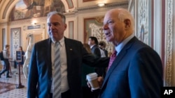 FILE - Sen. Tim Kaine, D-Va., left, and Sen. Ben Cardin, D-Md., both members of the Foreign Relations Committee, are pictured on Capitol Hill in Washington, Aug. 3, 2017.