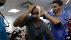 An injured Palestinian man receives treatment at the al-Shifa hospital, following Israeli airstrikes on Gaza City, central Gaza Strip, Nov. 5, 2023.