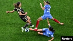 Jamaica's Solai Washington, left, with France's Estelle Cascarino and Kenza Dali during the FIFA Women’s World Cup at Sydney Football Stadium, in Sydney, Australia, July 23, 2023. Two crowdfunding campaigns raised money for the Jamaican team, nicknamed the Reggae Girlz.