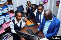 Ugandan human rights lawyer and activist leads fellow activists to file a petition challenging the signing of the new Anti-homosexuality law by President Yoweri Museveni, at the constitution court in Kampala, May 29, 2023.