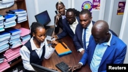 Ugandan human rights lawyer and activist leads fellow activists to file a petition challenging the signing of the new Anti-homosexuality law by President Yoweri Museveni, at the constitution court in Kampala, May 29, 2023.