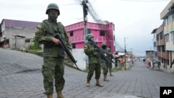 Soldiers patrol a residential area on the south side of Quito, Ecuador, Jan. 12, 2024, in the wake of the apparent escape of a powerful gang leader from prison.